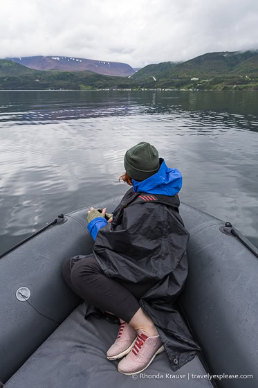 Woman at the front of a zodiac looking at the scenery of Bonne Bay. 