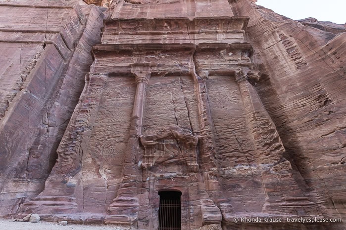 Tall tomb with columns on its facade.