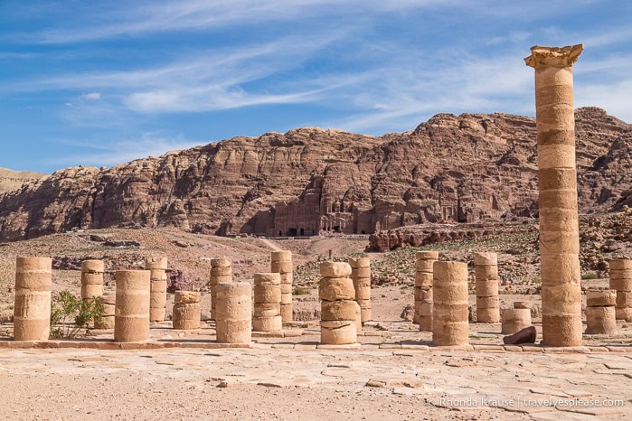 Columns at the Great Temple with a mountain and the Royal Tombs in the background.