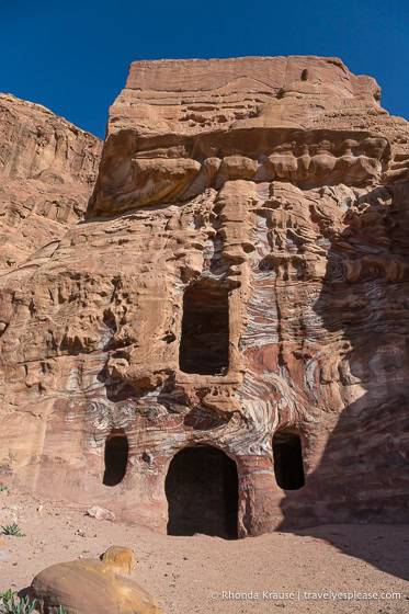 Colourful patterns in the rock facade of a tomb.