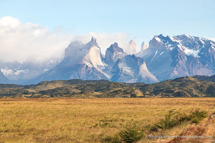 Grasslands and foothills in front of the Cuernos del Paine mountain.