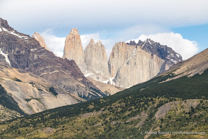 Partial view of the Torres del Paine peeking up between mountain slopes.