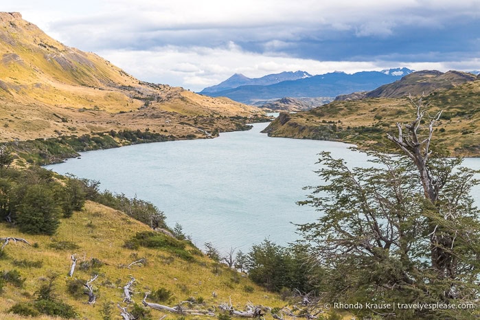 Lake framed by grassy hills.