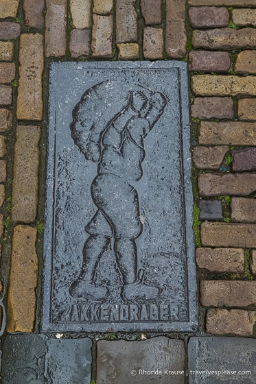 Plaque in the stone sidewalk.