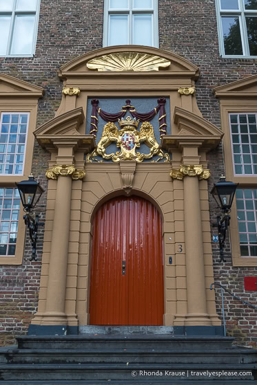 Red door with golden lions above.